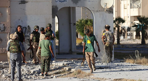 Fighters from Libyan forces allied with the UN-backed government take position during a battle