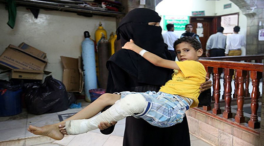 Yemeni mother carrying her wounded child