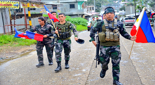 Philippine soldiers holding the National Flag