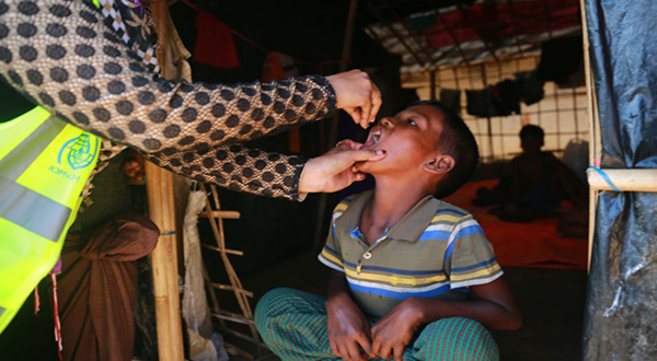 A Rohingya boy receives one of the first Cholera vaccine