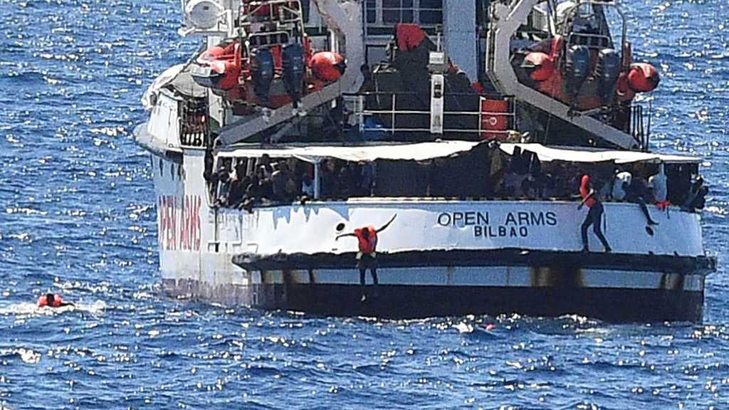 Desperate Migrants Jump Overboard From Charity Boat Off Italy