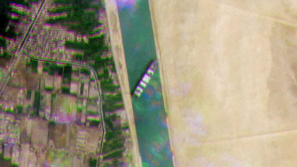 Tugs Work to Free Giant Container Ship Stranded in Suez Canal